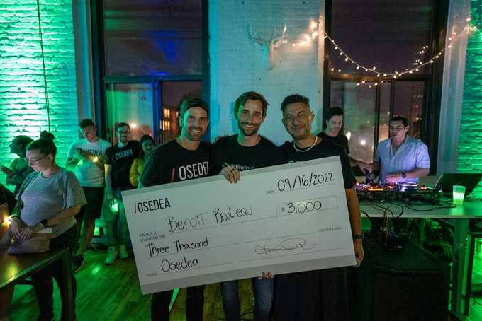 three men holding a winning prize